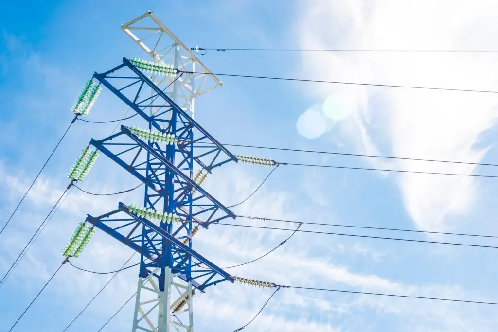 a high-voltage electricity pylons against blue sky and clouds power line electric post